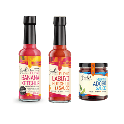 Three bottles of Rosales Kitchen sauces - banana ketchup, labuyo hot chilli sauce and adobo sauce on a white background
