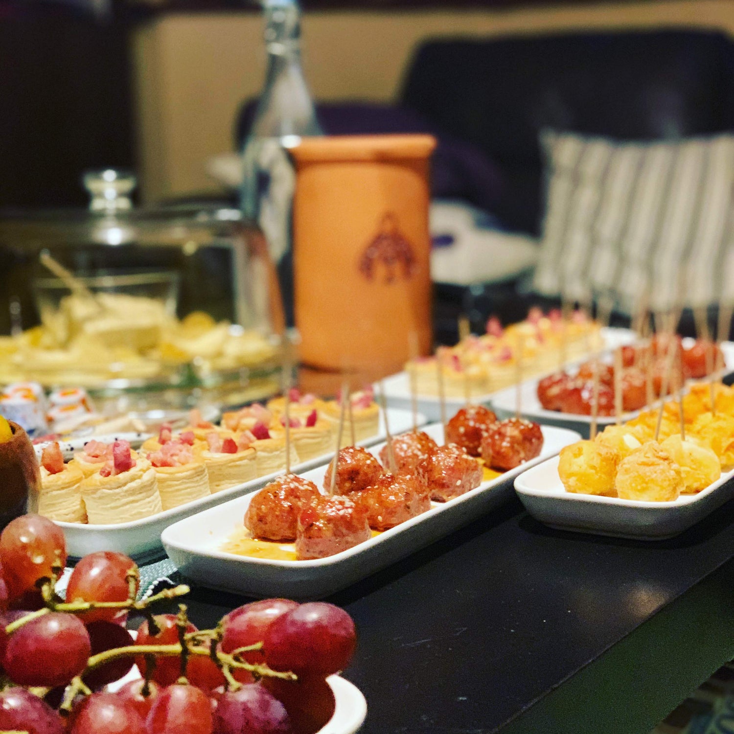 Assorted small dishes of food on a buffet table with blurred background